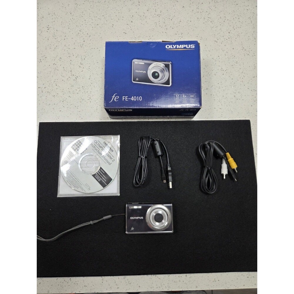 Olympus FE-4010 digital camera box featuring a 12-megapixel sensor and 4x Zoom